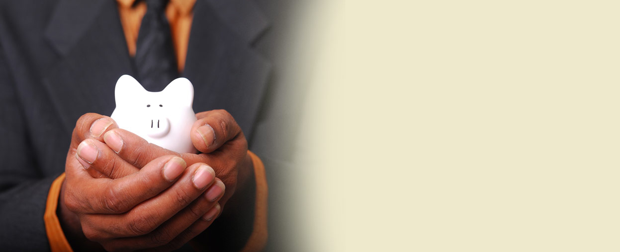 Hands holding a piggy bank while reviewing financial options